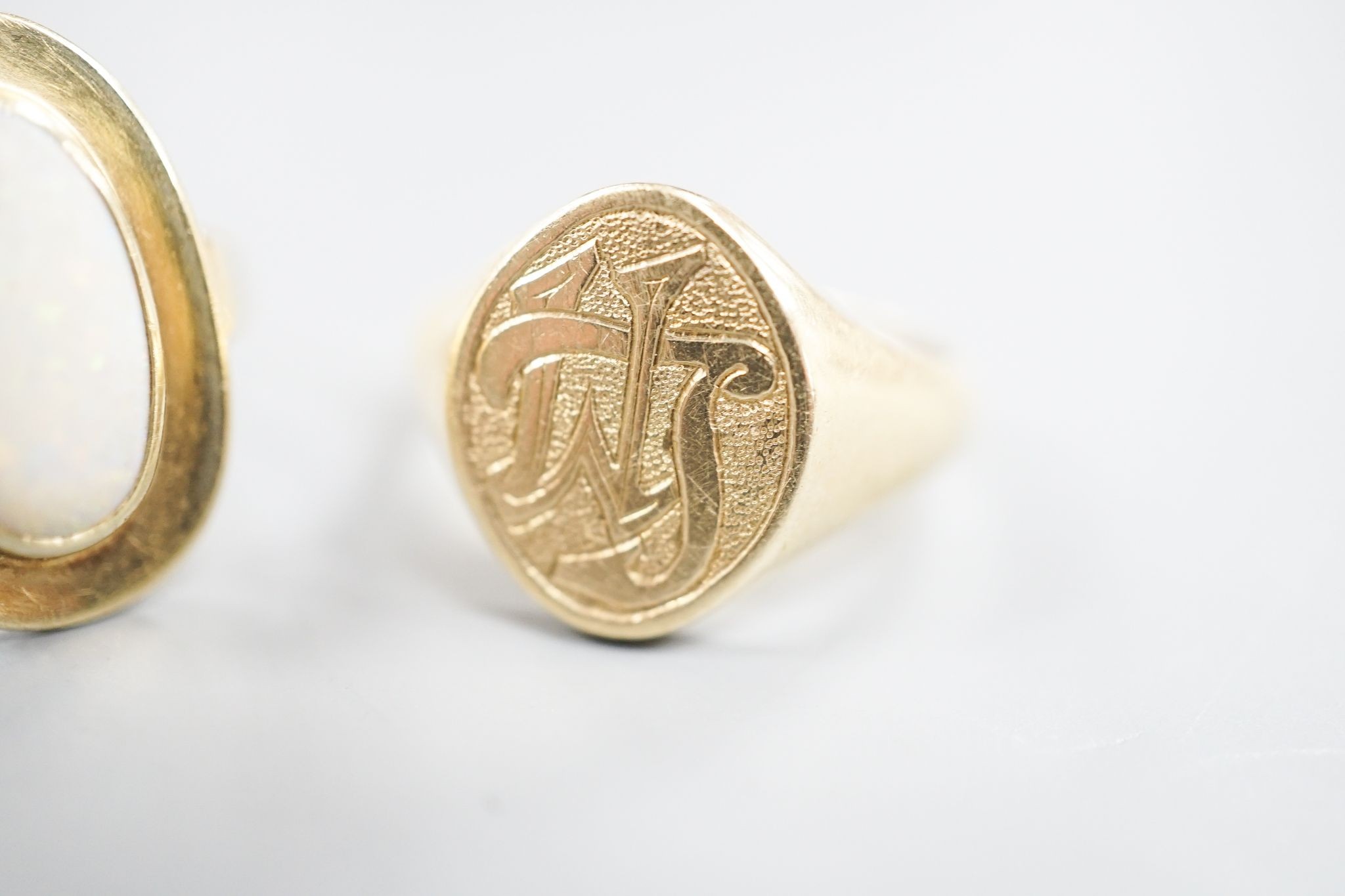 A 585 yellow metal signet ring, with engraved monogram, size O/P and a 585 and white metal and white metal oval dress ring, size O, gross weight 12.6 grams.